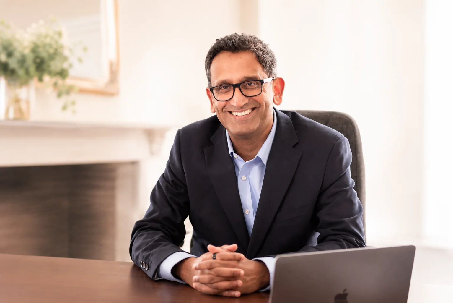 Professor Prasanna Sooriakumaran seated at his desk