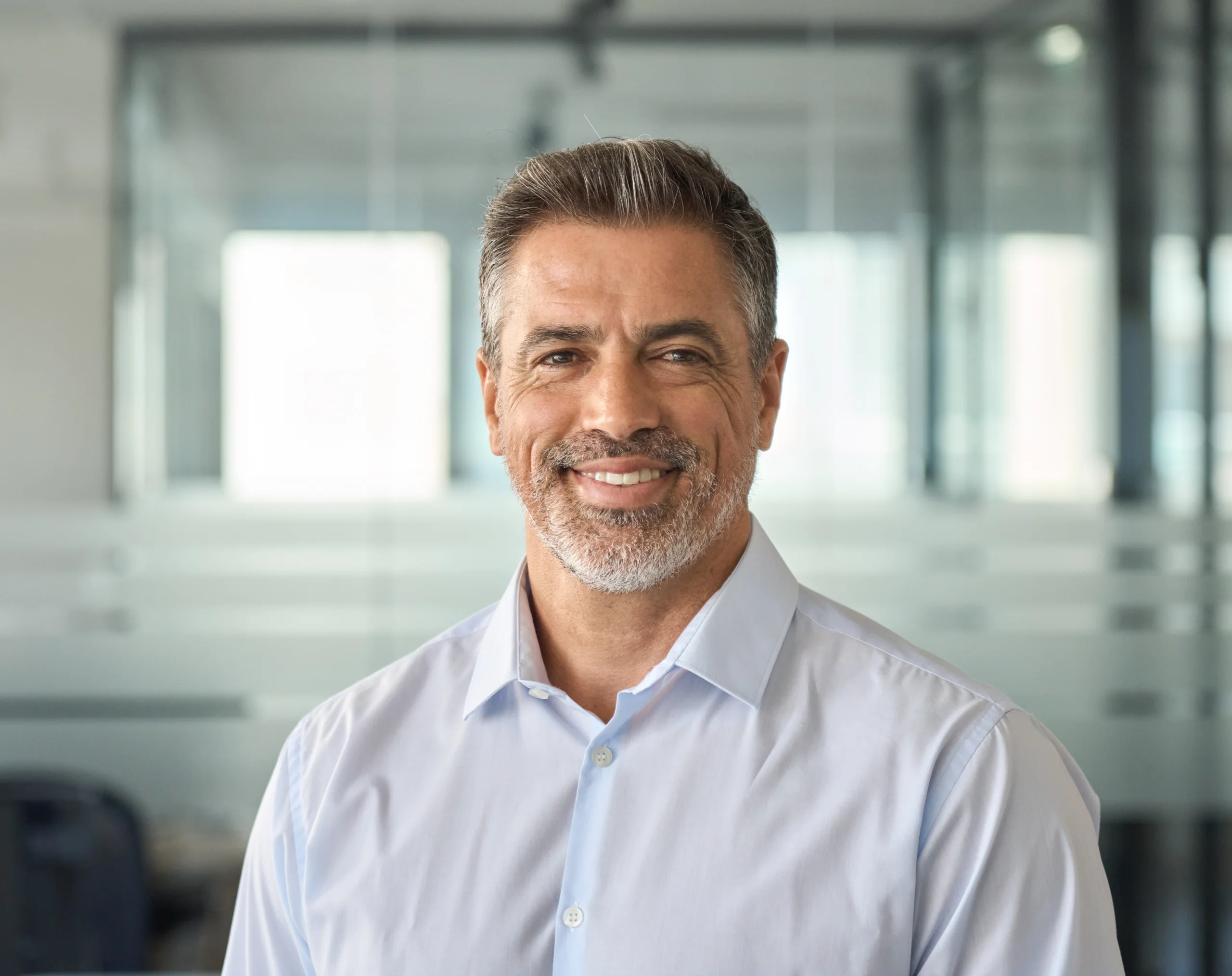 Smiling middle-aged man standing in an office