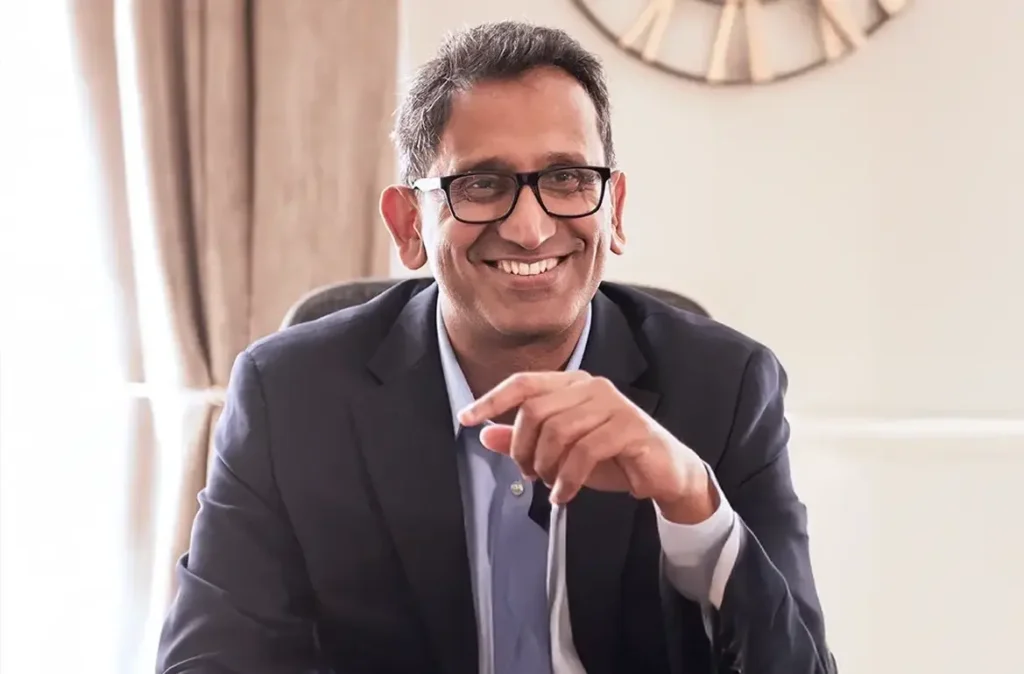 Professor Prasanna Sooriakumaran, prostate cancer surgeon in London, seated and smiling