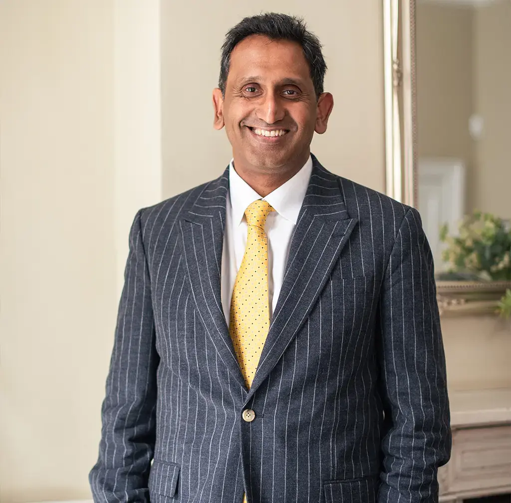 Professor Prasanna Sooriakumaran standing in his clinic