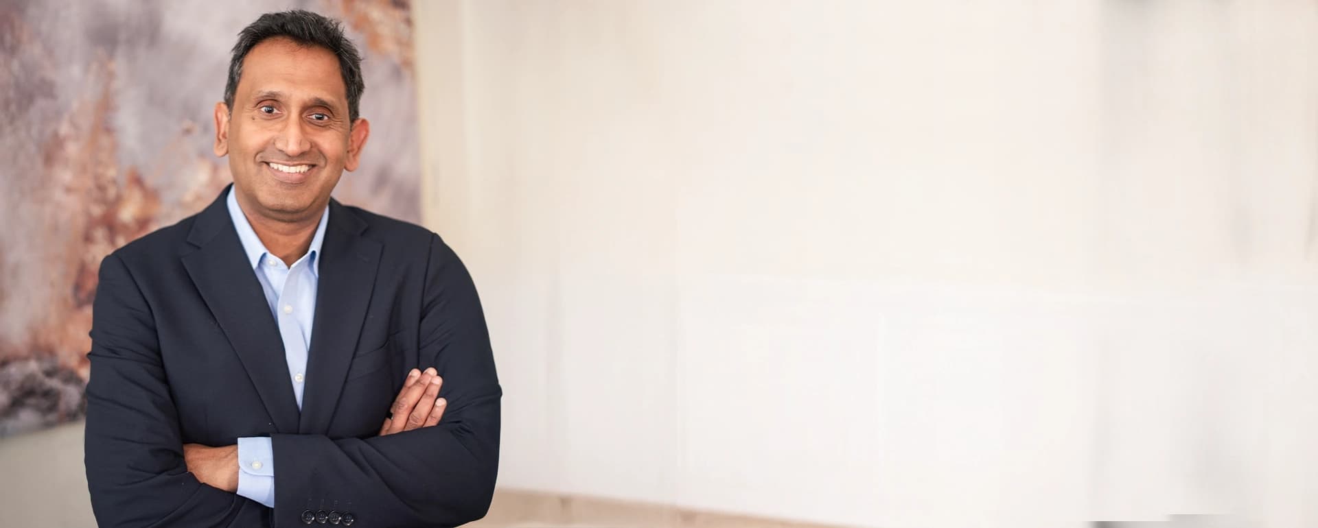 Professor Prasanna Sooriakumaran standing with arms folded