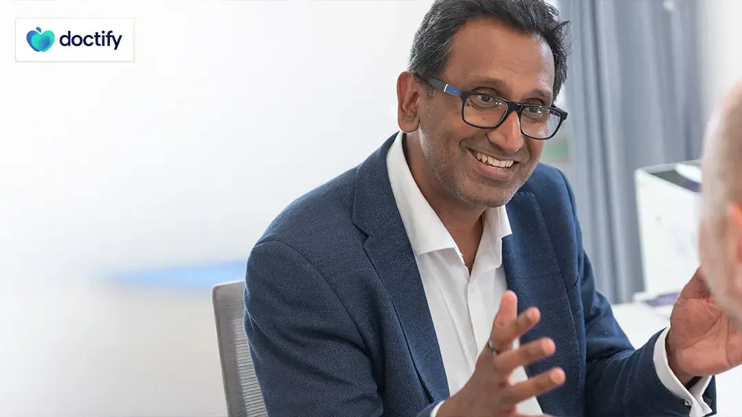 Professor Prasanna Sooriakumaran explaining benign prostatic hyperplasia to a patient