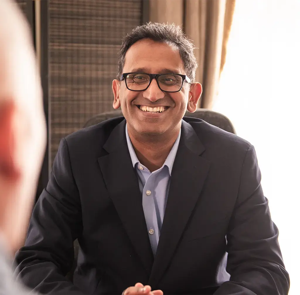 Professor Prasanna Sooriakumaran smiling during a consultation