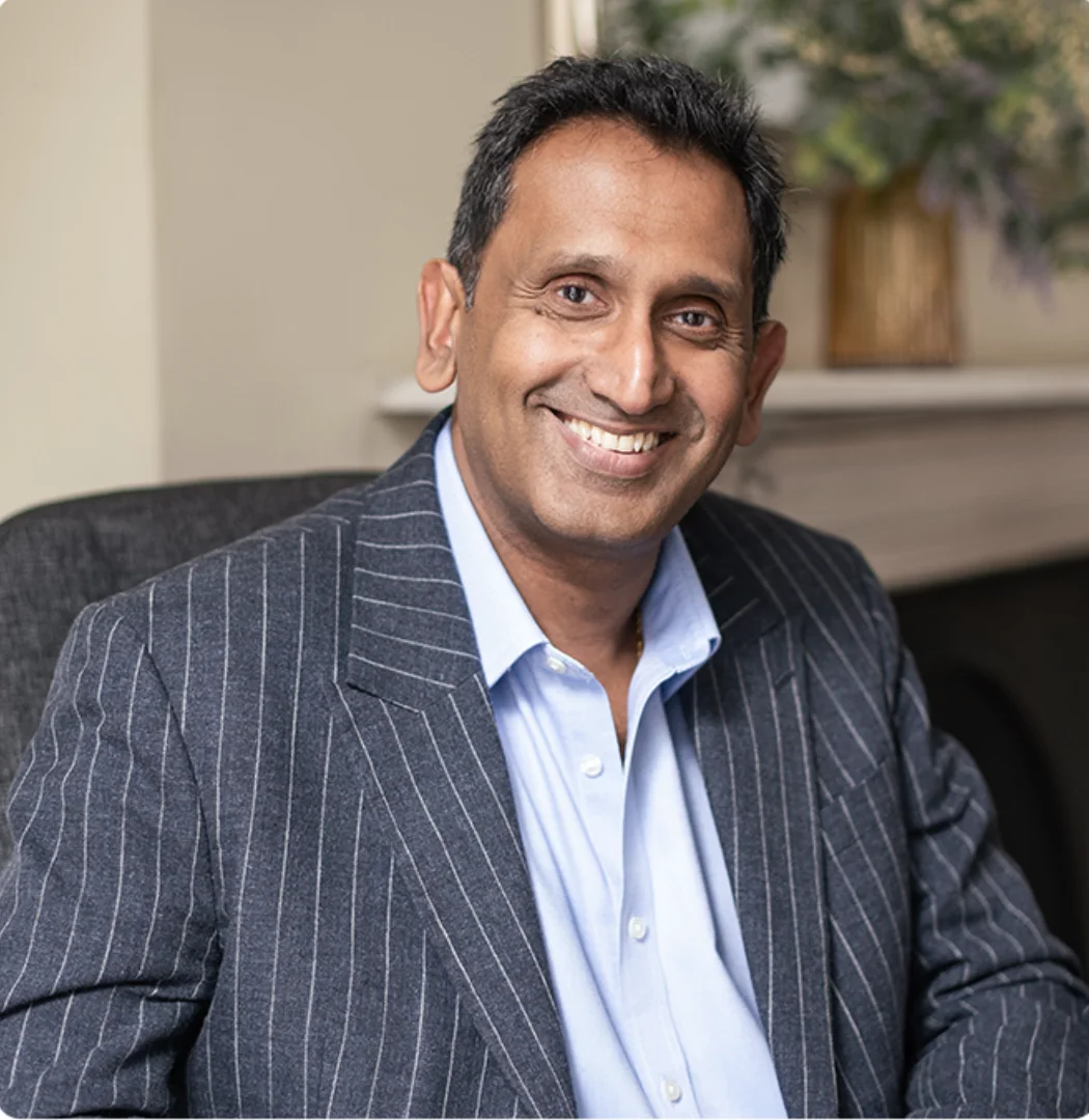 Professor Prasanna Sooriakumaran, smiling in clinic