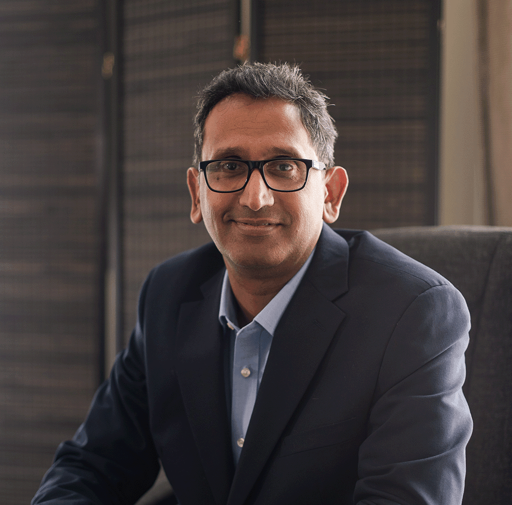 Professor Prasanna Sooriakumaran seated in his clinic