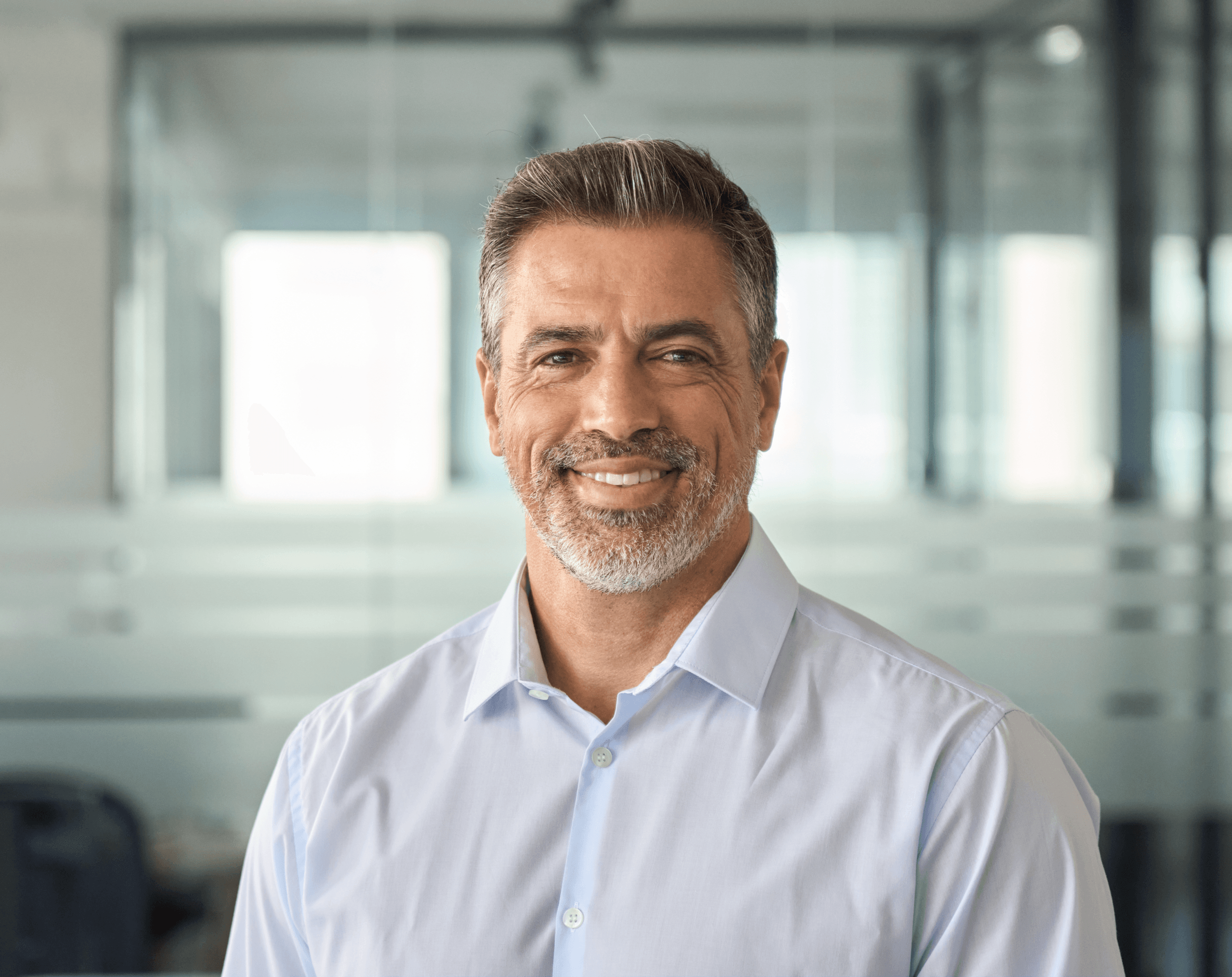 Smiling middle-aged man standing in an office
