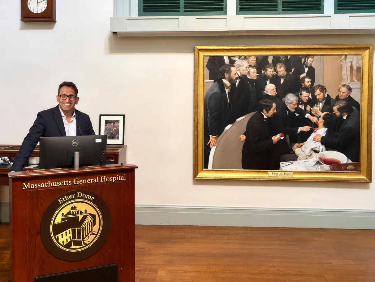 Professor Prasanna Sooriakumaran at the lectern in the Ether Dome, Massachusetts General Hospital