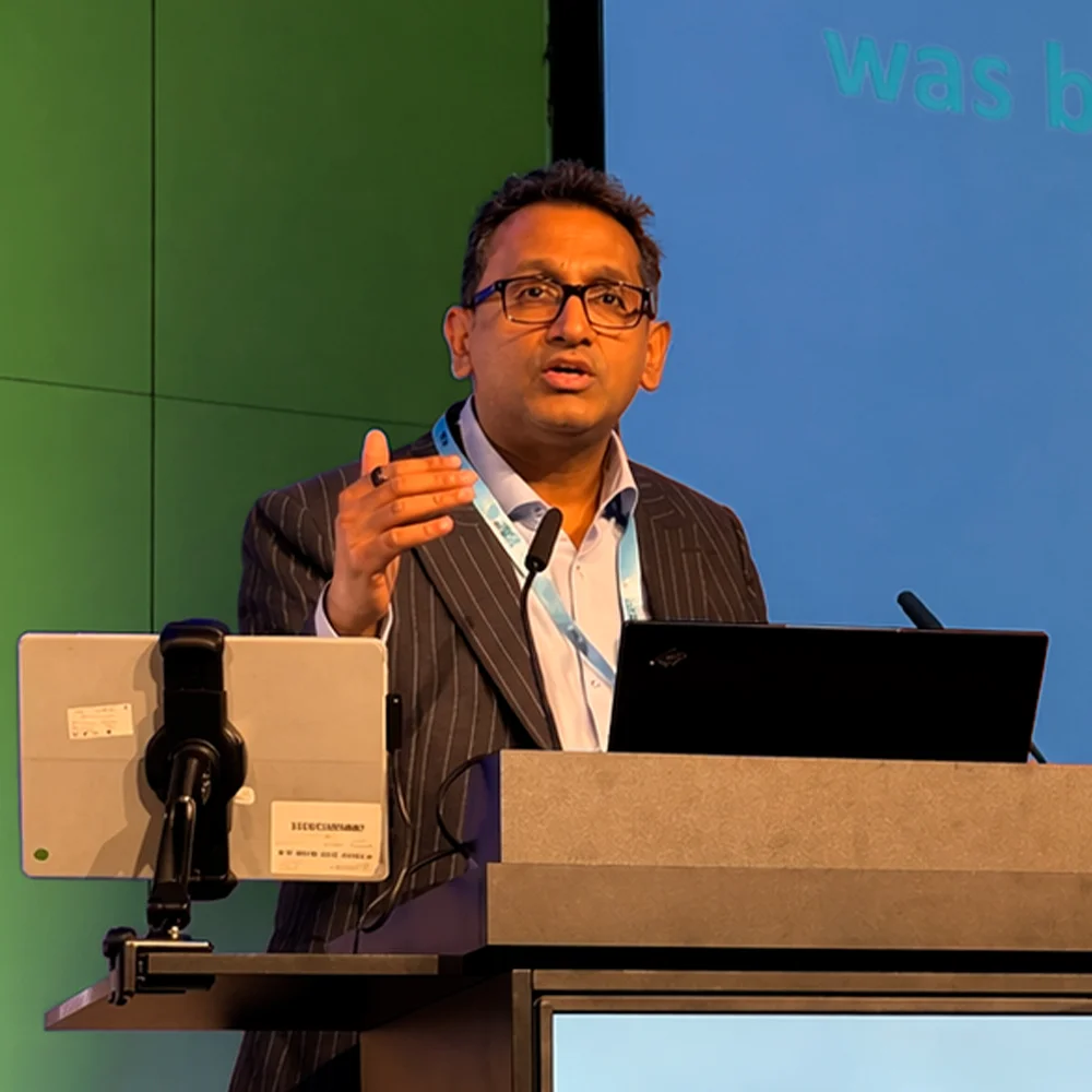 Professor Prasanna Sooriakumaran presenting at a lectern